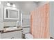 Cozy bathroom with neutral tile backsplash, white fixtures and cabinet storage at 896 Winn Rd, Douglasville, GA 30134