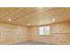 Spacious bedroom with tongue-and-groove wood walls and a large window at 896 Winn Rd, Douglasville, GA 30134