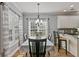 A bright dining room featuring a classic chandelier, neutral paint, and a view into the kitchen at 896 Winn Rd, Douglasville, GA 30134