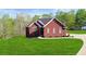 Charming red brick home featuring a well-manicured lawn and lovely landscaping at 896 Winn Rd, Douglasville, GA 30134