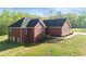 Side view of red brick home features updated windows, roof, and landscaping at 896 Winn Rd, Douglasville, GA 30134