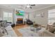 Comfortable living room with a fireplace, large windows, and plush seating at 896 Winn Rd, Douglasville, GA 30134