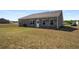 Back exterior view of home and wide backyard space at 1259 Fendt Dr, Locust Grove, GA 30248