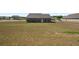 Backyard view of the home with a spacious grassy area at 1259 Fendt Dr, Locust Grove, GA 30248