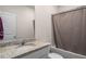 Well-lit bathroom features granite countertop, white cabinets, and shower-tub combo at 1259 Fendt Dr, Locust Grove, GA 30248