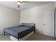 Neutral bedroom with ceiling fan, bed, and door at 1259 Fendt Dr, Locust Grove, GA 30248