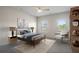 Cozy bedroom features a ceiling fan, neutral colors, and two windows, creating a serene and restful ambiance at 1259 Fendt Dr, Locust Grove, GA 30248