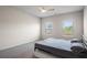 Comfortable bedroom with neutral walls and carpet, accentuated by natural light streaming through its two windows at 1259 Fendt Dr, Locust Grove, GA 30248