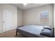 Bedroom featuring a ceiling fan, window, closet door, and bed frame with bedding at 1259 Fendt Dr, Locust Grove, GA 30248