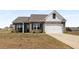 Charming brick home featuring stone accents, a two-car garage, and a well-manicured lawn at 1259 Fendt Dr, Locust Grove, GA 30248