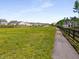 Walking trail with expansive green space and views of the surrounding neighborhood homes at 1259 Fendt Dr, Locust Grove, GA 30248