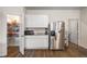 Bright kitchen area with stainless steel refrigerator, pantry, and ample storage, blending style with functionality at 1259 Fendt Dr, Locust Grove, GA 30248