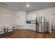 Kitchen/dining area featuring stainless steel refrigerator and a breakfast area, providing a welcoming gathering space at 1259 Fendt Dr, Locust Grove, GA 30248