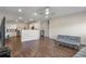 Open-concept living area with view into kitchen, featuring hardwood floors and natural light at 1259 Fendt Dr, Locust Grove, GA 30248