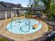 Community splash pad with colorful water features and playground in a well-maintained common area at 1259 Fendt Dr, Locust Grove, GA 30248