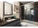 Elegant bathroom with granite countertop, modern fixtures, and glass-enclosed shower and tub at 1412 Woodbine Se Ave, Atlanta, GA 30317