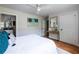 Bright bedroom with hardwood floors, neutral paint, and a view into the en-suite bathroom at 1412 Woodbine Se Ave, Atlanta, GA 30317
