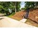 Charming home featuring wooden staircase and landscaped hillside for added curb appeal at 1412 Woodbine Se Ave, Atlanta, GA 30317