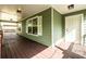 Spacious covered front porch with a white door and a view of a porch swing at 1412 Woodbine Se Ave, Atlanta, GA 30317