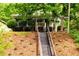 Charming front yard featuring landscaped hillside and steps up to the home at 1412 Woodbine Se Ave, Atlanta, GA 30317