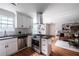 Modern kitchen with stainless steel appliances, white cabinets, and a view into the living room at 1412 Woodbine Se Ave, Atlanta, GA 30317