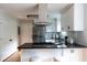 Well-lit kitchen features stainless steel appliances and white cabinetry at 1412 Woodbine Se Ave, Atlanta, GA 30317