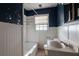 Bathroom featuring a tub, tiled walls, vanity, and navy blue accent walls at 1594 Lincoln Se Ave, Atlanta, GA 30317