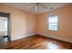 Bedroom featuring hardwood floors, a ceiling fan, and a window letting in natural light at 1594 Lincoln Se Ave, Atlanta, GA 30317
