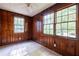 Cozy bedroom with wood paneled walls, tiled floor, and bright, sunlit windows at 1594 Lincoln Se Ave, Atlanta, GA 30317
