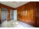 Bedroom featuring tiled floors, wood paneled walls, a closet and an ensuite at 1594 Lincoln Se Ave, Atlanta, GA 30317