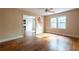 Spacious living room with hardwood floors, a ceiling fan, and bright windows overlooking the property at 1594 Lincoln Se Ave, Atlanta, GA 30317