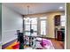 Bright dining area featuring a glass table, modern chandelier, and access to the outdoor space at 2325 Thackery Rd, Snellville, GA 30078