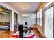 Dining room with wood flooring, an elegant chandelier, and access to the outside at 2325 Thackery Rd, Snellville, GA 30078