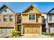 Charming two-story home features a well-maintained lawn and attached two-car garage at 2325 Thackery Rd, Snellville, GA 30078