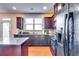 Galley kitchen features stainless appliances, granite counters, and wood floors at 2325 Thackery Rd, Snellville, GA 30078