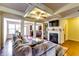 Spacious living room featuring a coffered ceiling, open layout, fireplace, and views of the dining area at 2325 Thackery Rd, Snellville, GA 30078