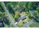 An aerial view of home on a verdant lawn, and a road leading to the property at 507 Honeysuckle Ln, Woodstock, GA 30188