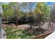 Overlook the green backyard from the back deck, with treeline, creek bed, and plenty of space for activities at 507 Honeysuckle Ln, Woodstock, GA 30188