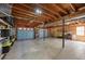 Spacious basement with exposed beams, two garage doors, and ample storage at 507 Honeysuckle Ln, Woodstock, GA 30188