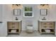 Modern bathroom features dual vanities, wood cabinets, and stylish lighting at 507 Honeysuckle Ln, Woodstock, GA 30188