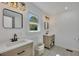 Modern bathroom with double sinks, wood cabinets, and stylish black fixtures at 507 Honeysuckle Ln, Woodstock, GA 30188