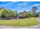Landscaped property featuring a quaint home with surrounding mature trees at 507 Honeysuckle Ln, Woodstock, GA 30188