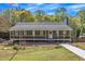 Charming single-story home with a welcoming front porch and landscaped yard at 507 Honeysuckle Ln, Woodstock, GA 30188