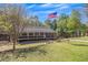 Beautiful home featuring well-maintained lawn, mature trees, and American flag at 507 Honeysuckle Ln, Woodstock, GA 30188