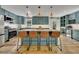 Well-equipped kitchen with an island, bar stools, stainless appliances, and custom cabinets at 507 Honeysuckle Ln, Woodstock, GA 30188