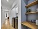 A laundry room and mud room with modern appliances and wood shelving at 507 Honeysuckle Ln, Woodstock, GA 30188