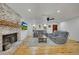 Bright living area with hardwood floors, brick fireplace, and ample seating at 507 Honeysuckle Ln, Woodstock, GA 30188