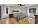 A main bedroom with many windows, light wood floors, and a ceiling fan at 507 Honeysuckle Ln, Woodstock, GA 30188