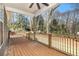 Spacious wooden back porch with metal railings offers serene views of the surrounding wooded landscape at 5260 Moore St, Stone Mountain, GA 30083