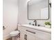 Clean powder room featuring modern fixtures, a sleek white vanity and neutral walls at 5260 Moore St, Stone Mountain, GA 30083